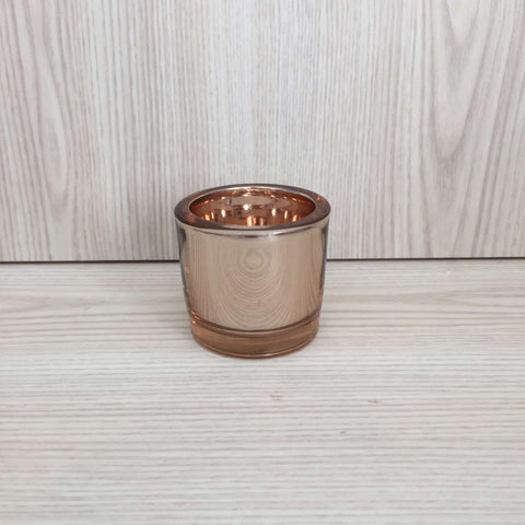 Dixon Shiny Tealight Holder in Rose Gold on Wooden Surface
